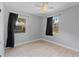 Bedroom with tiled floor, ceiling fan and curtains on the windows at 207 Rose St, Auburndale, FL 33823