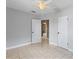 Bedroom featuring tile floors, light gray walls, ceiling fan and two entry doors at 207 Rose St, Auburndale, FL 33823