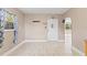 Bright entryway featuring a tiled floor, white front door, and an archway leading to other rooms at 207 Rose St, Auburndale, FL 33823