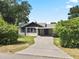 Charming single-story home with covered carport and mature landscaping at 207 Rose St, Auburndale, FL 33823