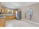 Spacious kitchen featuring wooden cabinets, stainless steel appliances, and tile backsplash at 207 Rose St, Auburndale, FL 33823