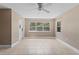 Living room featuring tile floors, neutral paint, large windows and a ceiling fan at 207 Rose St, Auburndale, FL 33823