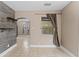 Living room with decorative wall, tiled flooring, built-in shelves, and natural light at 207 Rose St, Auburndale, FL 33823