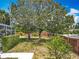 View of the well-maintained, fenced backyard featuring mature trees, and neat landscaping at 2147 Whitfield Ln, Orlando, FL 32835