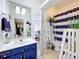 Charming bathroom featuring blue vanity, framed mirror, and coordinating blue and white striped shower curtain and decor at 2147 Whitfield Ln, Orlando, FL 32835