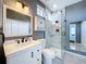 Modern bathroom with a stand-up glass shower, a large mirror, modern lighting, and sleek fixtures at 2147 Whitfield Ln, Orlando, FL 32835