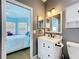 Well-lit bathroom featuring a white vanity with black hardware and a toilet at 2147 Whitfield Ln, Orlando, FL 32835