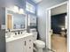 Bright bathroom features a white vanity, ample storage, and access to an adjacent bedroom, creating a functional space at 2147 Whitfield Ln, Orlando, FL 32835