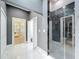 Modern bathroom boasts marble floors, walk-in shower with black stone wall, and neutral color palette at 2147 Whitfield Ln, Orlando, FL 32835