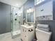 This remodeled bathroom has a glass shower, a vanity with dark fixtures, and ample storage space at 2147 Whitfield Ln, Orlando, FL 32835