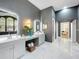 Elegant bathroom featuring dual vanities, marble floors, and arched windows at 2147 Whitfield Ln, Orlando, FL 32835