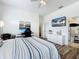 Bright bedroom with wood floors, a large bed, and a view of the bathroom at 2147 Whitfield Ln, Orlando, FL 32835