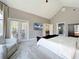 Bright primary bedroom with high ceilings, arched windows, and access to a patio at 2147 Whitfield Ln, Orlando, FL 32835