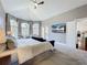 Bright primary bedroom with high ceilings, carpet floors, arched windows, and a ceiling fan at 2147 Whitfield Ln, Orlando, FL 32835