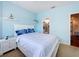 This bedroom is brightly painted, featuring a white bed frame and nightstands, and access to a bathroom at 2147 Whitfield Ln, Orlando, FL 32835