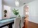 Stylish dining room with a dark wood table and views to the entry and kitchen at 2147 Whitfield Ln, Orlando, FL 32835