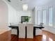 Elegant dining room with hardwood floors, a modern chandelier, and seating for six at 2147 Whitfield Ln, Orlando, FL 32835