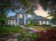 Charming two-story home with lush landscaping, mature trees and inviting curb appeal at 2147 Whitfield Ln, Orlando, FL 32835