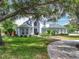 Charming two-story home with lush green lawn, mature trees and inviting curb appeal at 2147 Whitfield Ln, Orlando, FL 32835