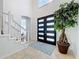 Bright foyer featuring modern front door, tile floors, staircase, and natural light at 2147 Whitfield Ln, Orlando, FL 32835
