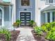 Stunning modern-style front door framed by manicured landscaping and architectural details at 2147 Whitfield Ln, Orlando, FL 32835