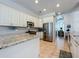Bright kitchen boasts white cabinets, stainless steel appliances, and granite countertops at 2147 Whitfield Ln, Orlando, FL 32835