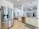 Open concept kitchen with stainless steel appliances and white cabinets at 2147 Whitfield Ln, Orlando, FL 32835