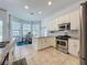 Bright kitchen with stainless steel appliances and a view to the breakfast nook at 2147 Whitfield Ln, Orlando, FL 32835