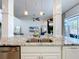 Open concept kitchen with stainless steel appliances and white cabinets at 2147 Whitfield Ln, Orlando, FL 32835