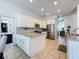 Bright kitchen boasts white cabinets, stainless steel appliances, and granite countertops at 2147 Whitfield Ln, Orlando, FL 32835