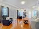 Cozy living room with a light-colored couch, dark armchairs, and hardwood floors at 2147 Whitfield Ln, Orlando, FL 32835