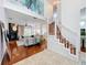 Inviting living room featuring hardwood floors, fireplace, open staircase, and soaring ceilings at 2147 Whitfield Ln, Orlando, FL 32835