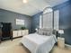 This bedroom boasts natural light from a large window, complemented by tasteful decor and a comforting color palette at 2147 Whitfield Ln, Orlando, FL 32835