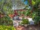 Outdoor kitchen and bar in a tropical landscaped backyard provide a relaxing atmosphere at 2147 Whitfield Ln, Orlando, FL 32835