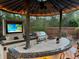 Outdoor kitchen with built-in grill, bar, and TV is perfect for entertaining at 2147 Whitfield Ln, Orlando, FL 32835