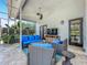 Comfortable screened-in patio with wicker furniture, ceiling fan, and outdoor entertainment setup at 2147 Whitfield Ln, Orlando, FL 32835