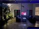 Inviting outdoor patio with seating, plants, lighting, and entertainment in a tranquil setting at 2147 Whitfield Ln, Orlando, FL 32835