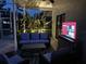 Well-lit outdoor patio featuring comfortable seating, lush plants, and a modern television at 2147 Whitfield Ln, Orlando, FL 32835