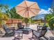 Backyard patio area with comfortable seating and umbrella offers a relaxing outdoor retreat at 2147 Whitfield Ln, Orlando, FL 32835