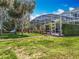 Backyard view of a screened in pool area and landscaped yard at 2147 Whitfield Ln, Orlando, FL 32835