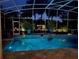 Inviting screened-in pool with serene lighting and manicured landscaping offering a tranquil retreat at 2147 Whitfield Ln, Orlando, FL 32835
