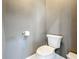This powder room features a standard white toilet, a toilet paper holder, and gray walls at 2147 Whitfield Ln, Orlando, FL 32835