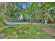 Expansive backyard featuring a pool, mature trees, and a play set at 216 E Vanderbilt St, Orlando, FL 32804