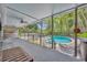 Covered backyard patio with a hot tub and seating overlooks a serene pool surrounded by bamboo at 216 E Vanderbilt St, Orlando, FL 32804