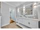 Bright bathroom with double vanity, tile floors, and a framed mirror creates a spa-like feel at 216 E Vanderbilt St, Orlando, FL 32804