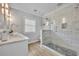 Modern bathroom features a marble vanity, glass shower and wood-style tile floor at 216 E Vanderbilt St, Orlando, FL 32804