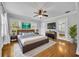 Bright bedroom featuring hardwood floors, a ceiling fan, and natural light from the windows at 216 E Vanderbilt St, Orlando, FL 32804