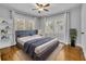Serene bedroom with hardwood floors, light grey walls, and ample natural light at 216 E Vanderbilt St, Orlando, FL 32804