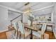 Elegant dining area with a modern chandelier, stylish chairs, and a view into the updated kitchen at 216 E Vanderbilt St, Orlando, FL 32804