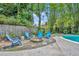 Backyard fire pit area with Adirondack chairs is ideal for cozy outdoor gatherings at 216 E Vanderbilt St, Orlando, FL 32804